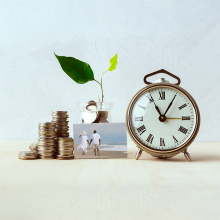 Coins, a picture, a clock, and a plant growing out of a jar of coins
